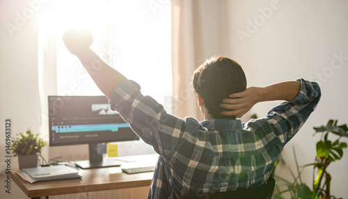 Relaxed Man in Home Office with Sunlight Streaming Through Window