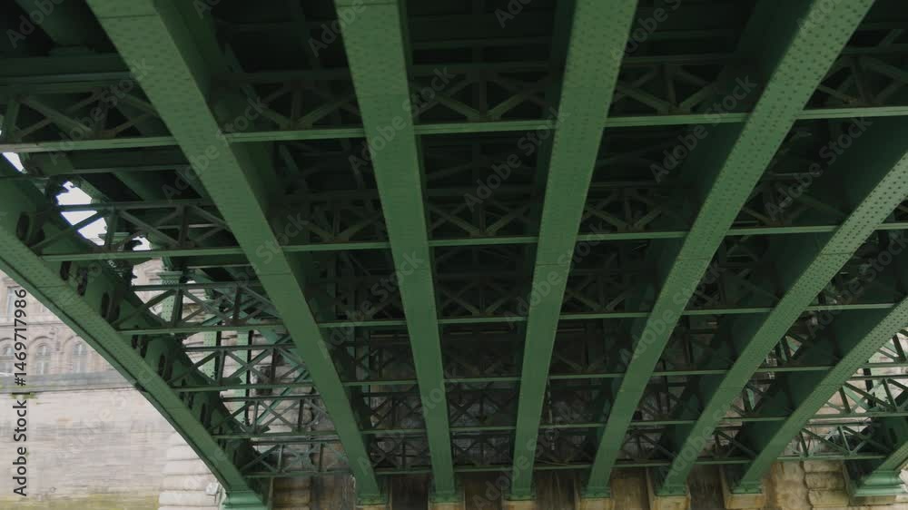 Riverboat cruise on the Seine. A boat sails under the green metal structures of the Pont Notre-Dame bridge over the Seine River, Paris, France. View of the Seine River, bridge and embankment.