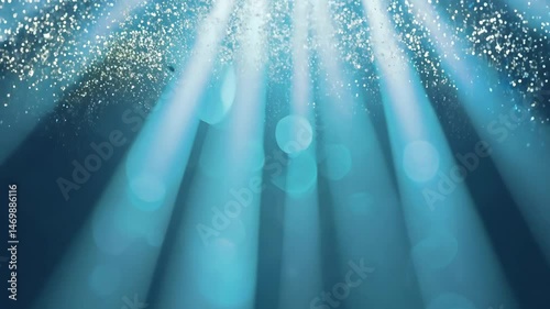 Underwater view of clear ocean surface with sunlight rays passing through blue water, creating a peaceful scene showing purity, calmness and natural marine light beauty