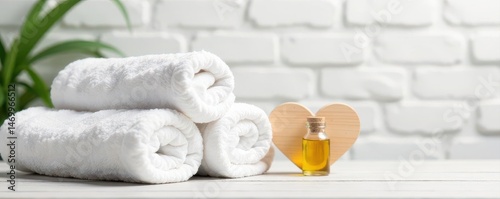 White brick backdrop, spa towels, essential oil, wooden heart , decor, serenity