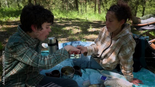 Mother and Son Enjoying a Picnic in Nature