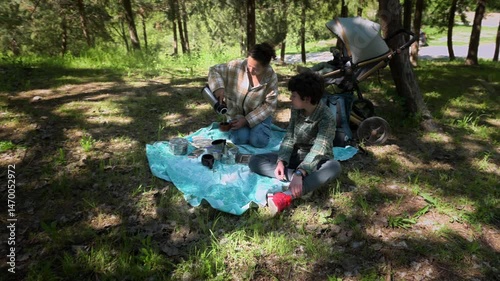 Family Picnic in the Woods: Mother and Child Enjoy Quality Time in Nature