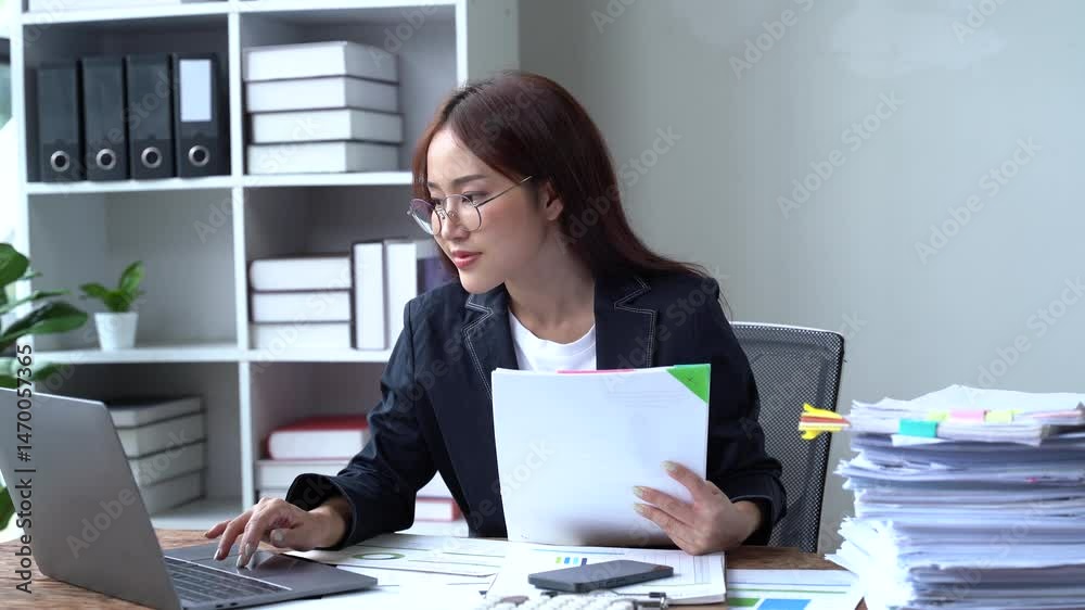 Efficiency in the Office: A professional engrossed in her work, surrounded by office supplies and technology. capturing a moment of focus and commitment. Efficiency in the Office: A professional engrossed in her work, surrounded by office supplies and technology. capturing a moment of focus and commitment.