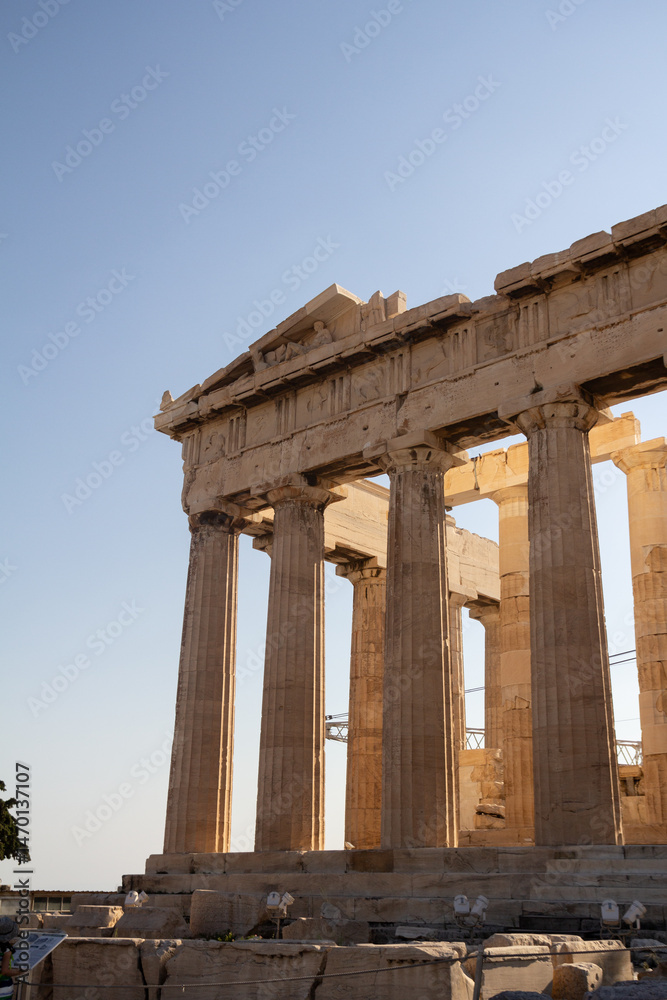 The Parthenon temple glowing in sunlight on a clear day in Athens. A majestic and timeless view of classical Greece. The Parthenon temple glowing in sunlight on a clear day in Athens. A majestic and timeless view of classical Greece.