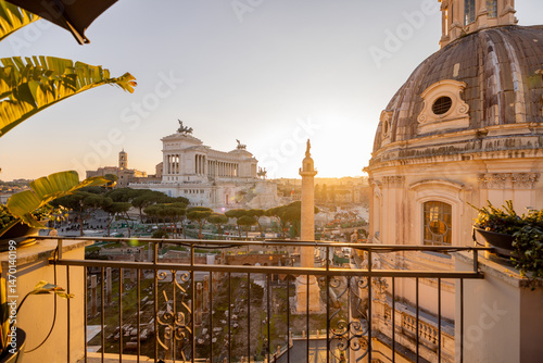 Photography Sunset light washes over the ancient ruins of the Roman Forum and the dome of th