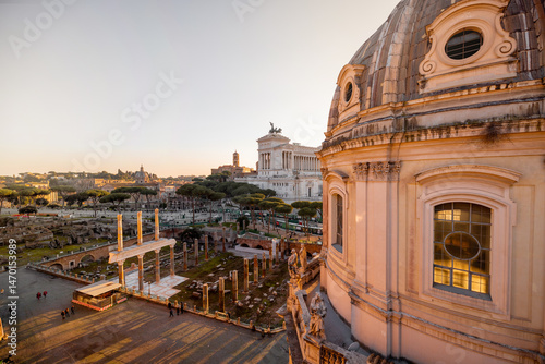 Canvas Print Sunset light washes over the ancient ruins of the Roman Forum and the dome of th