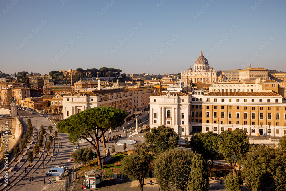 Obraz premium A sweeping view over Vatican City and St. Peters Basilica from Castel Sant Angelo, capturing the layout of Via della Conciliazione flanked by historic buildings and Roman pines
