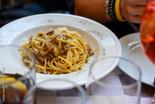 Fresh pasta   spaghetti  carbonara and Aperol Spritz  at  typical italian resaturant at Trastevere   neighbourhood at Rome 