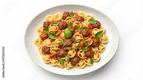 Obraz na płótnie A tempting dish features tender pasta shaped like shells, paired with savory meatballs and garnished with fresh basil. The vibrant colors and inviting aromas create a delightful meal w salonie