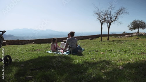 Family Picnic in the Mountains: Mother and Children Enjoying Quality Time Outdoors