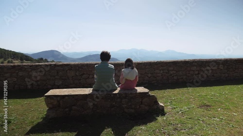 Mother and Daughter Enjoy a Mountain Picnic Snack