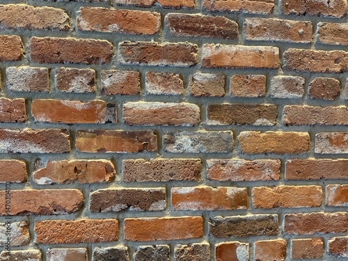 Brick wall texture. Detailed close-up of a red brick wall with rough texture, ideal for backgrounds, patterns, or construction themes.
