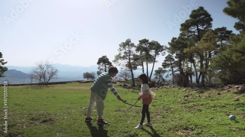 Brother and Sister Play Sword Fight in Sunny Field, Family Fun in Nature