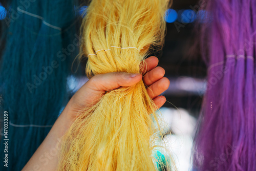 Photos Close-Up Hand Touch of Natural colorful silk threads and dyeing with raw materials, traditional Thai sericulture in the countryside