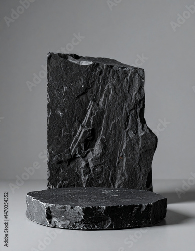 Minimalist black rock podium display. Geometric dark stone. Product presentation. Mock-up.