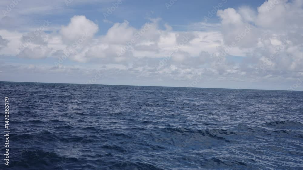Slow motion side view from boat in Indian ocean sailing between Seychelles islands in daytime Slow motion side view from boat in Indian ocean sailing between Seychelles islands in daytime
