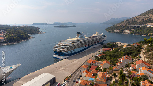 Aerial view of a cruise ship docked at the shore in Dubrovnik port. Dalmatia, Croatia, travel and transportation industry