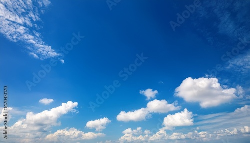 sunny day with blue skies and white clouds offer an abstract background for a copy space image