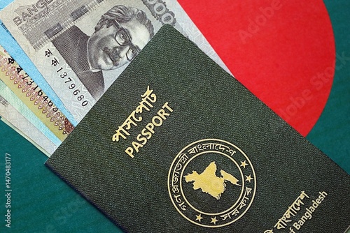 Bangladeshi taka money bills in big amount and passport lies on Bangladesh flag close up