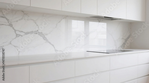 Modern kitchen design with marble backsplash and white minimalist cabinets and countertops