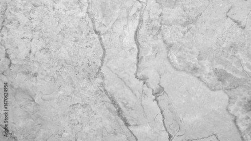A white marble wall with a crack in it. The crack is long and jagged, giving the wall a rough and uneven appearance