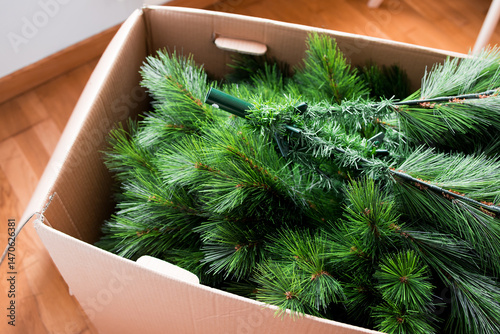 Cardboard box with disassembled artificial Christmas tree
