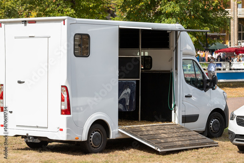 Obraz na płótnie Horse box cargo trailer transport with open tailgate with hay and manure and horse transportation van at farm or ranch