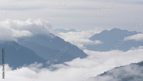 Misty grey peaks shrouded in low clouds, valley below unseen, vista, grey