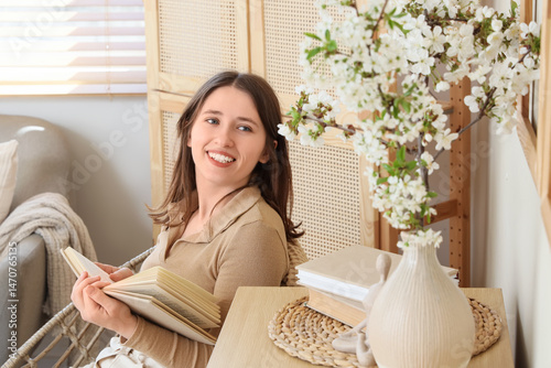Young woman reading book in...