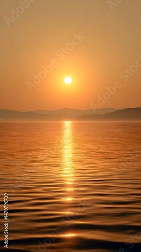 Scenic Golden Sunset Over Calm Water with Mountain Silhouettes and Sun Reflection