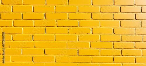 Vibrant Yellow Brick Wall Bright sunny yellow painted brick texture creating an energetic abstract background perfect for cheerful and eye-catching designs.