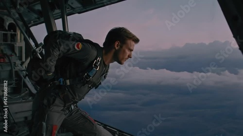 Person prepares to jump from airplane against colorful evening sky
