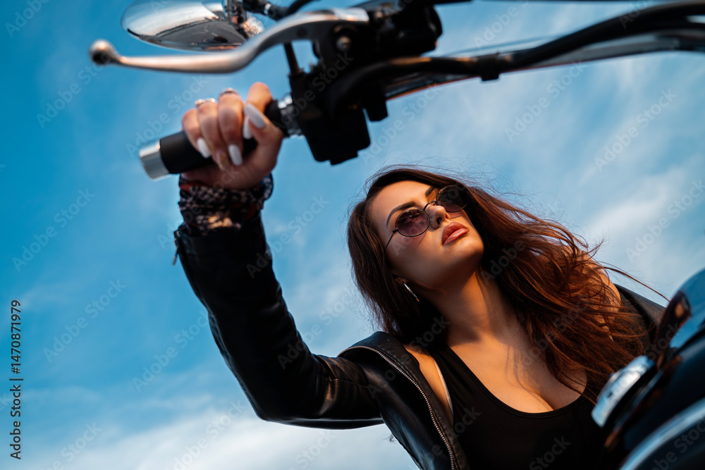 Obraz premium Shot from below attractive girl on motorcycle and holding hand on throttle 