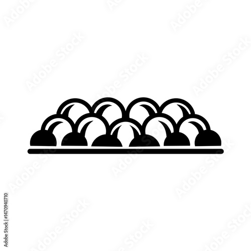 A platter of colorful round candies arranged neatly, showcasing vibrant hues against a white background