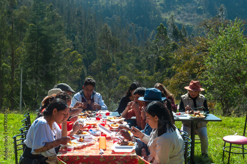 Latin american family enjoying outdoor meal in mountain scenery