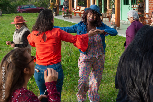 Group of diverse women dancing together in a garden party