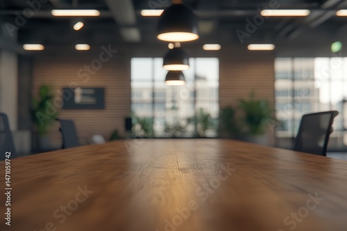 Modern office interior featuring a wooden conference table with blurred background elements