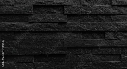 Dark stone wall texture featuring horizontal rectangular blocks in a close-up view. photo