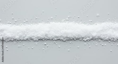 Strip of faux snow with scattered snowflakes on a neutral surface