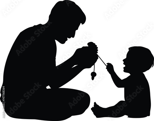 Father and baby playing with a toy depicting a silhouette of joy and parenthood