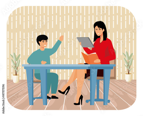 Teacher Assisting Young Student With Learning in a Classroom Setting.