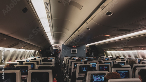 Inside and interior of a plane seats and passengers.