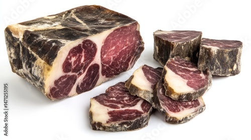 Smoked cured meat slices.  Dark, cured, and sliced meat product.  A block of cured meat and slices are arranged on a white background photo
