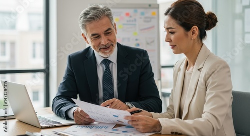 Business colleagues reviewing documents together