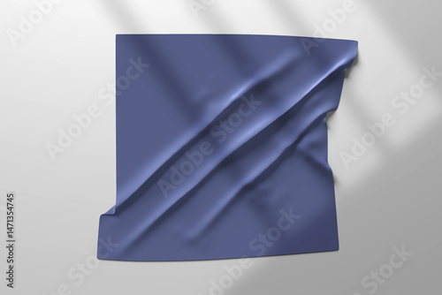 A minimal mockup featuring a draped indigo fabric pinned on a light grey wall, with soft shadows adding depth and realism. This scene is ideal for showcasing textile designs, logo placements, fabric b