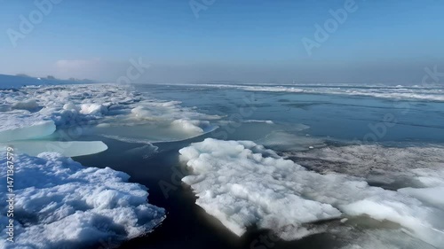 Wallpaper Mural Frozen Lake with Ice Floes, Blue Sky, and Distant Shoreline in Winter Scenery during a Sunny Day with Hazy Light Torontodigital.ca