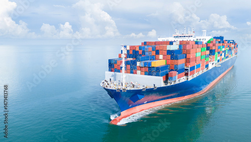 Aerial front view of a large cargo ship fully loaded with colorful shipping containers navigating through calm ocean water. Ideal for logistics, transport, and global trade concepts.