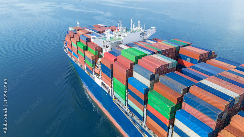 Fototapeta premium Aerial side view of a large cargo ship fully loaded with colorful shipping containers navigating through calm ocean water. Ideal for logistics, transport, and global trade concepts.