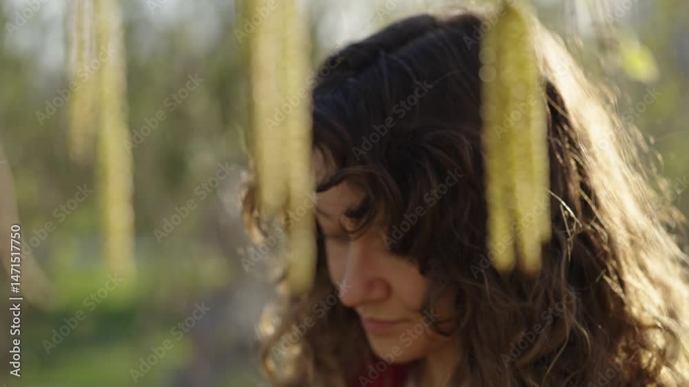 Experiencing intense spring allergic reaction near blooming birch trees, young woman suffering from sneezing, eye irritation, and respiratory discomfort during seasonal pollen exposure