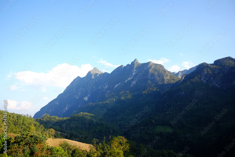 Fototapeta premium Beautiful landscape of valley Doi Luang Chiangdao mountain with cloud and blue sky, Chiangmai Province of Thailand. Destination travel 